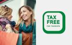 Na zdjęciu widać dwie uśmiechnięte kobiety oraz zielony napis tax free for tourists